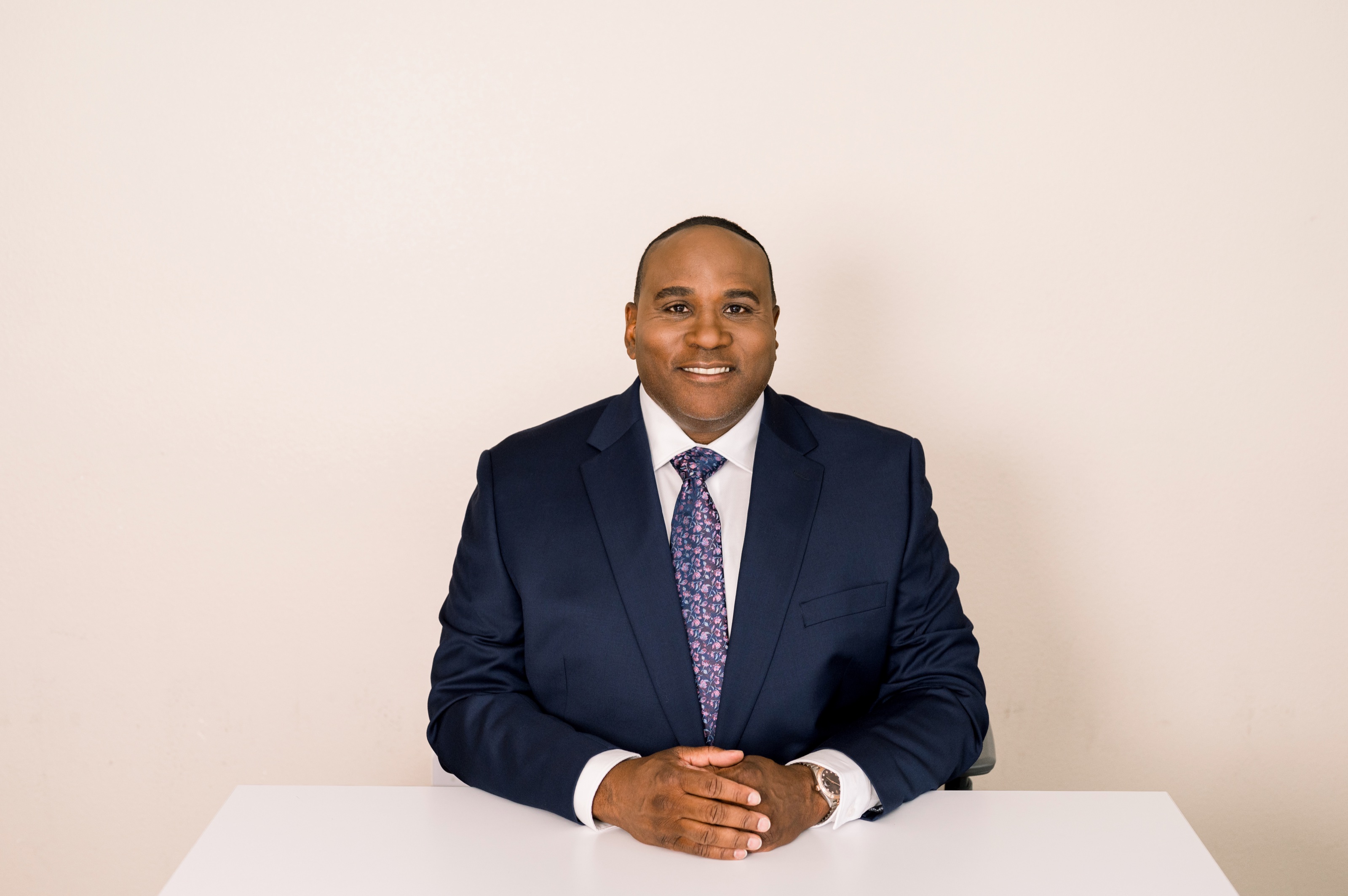Richard Ladson, Certified Medicaid Planner, wearing a navy suit and patterned tie